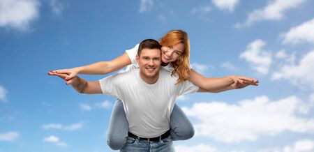 Happy couple in white t-shirts having funの写真素材