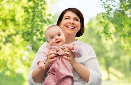 Happy middle-aged mother with little baby daughter