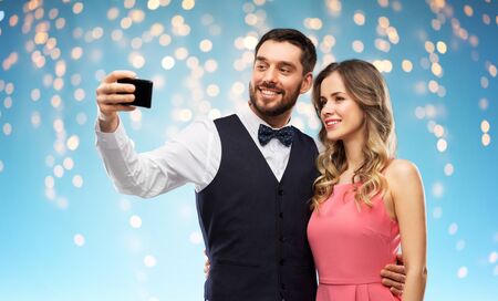 happy couple taking selfie by smartphone