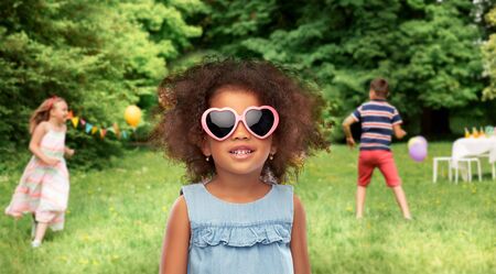 little african girl in sunglasses at summer partyの写真素材
