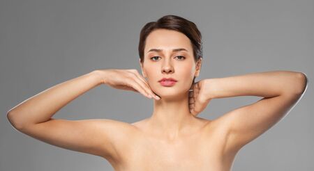 beautiful young woman touching her faceの写真素材