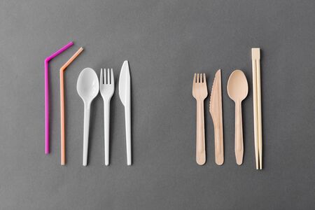 recycling, environment and eco friendly concept - close up of natural wooden spoon, knive, fork and...