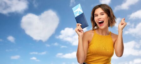 happy young woman with air ticket and passportの写真素材