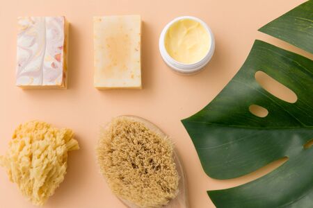 beauty, spa and bath concept - close up of crafted soap bar, natural bristle wooden brush, body...