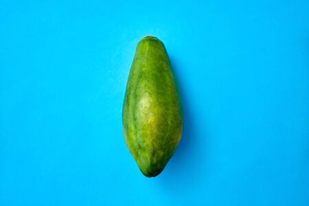 fruits, diet and food concept - close up of ripe papaya on blue background