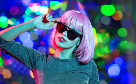 happy woman in pink wig and black sunglasses
