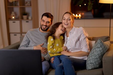 happy family watching tv at home at night