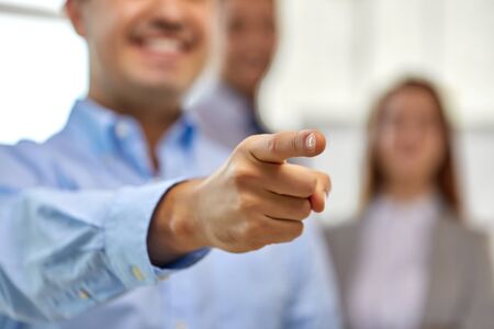 business, gesture and people concept - close up of smiling businessman pointing fingerの写真素材