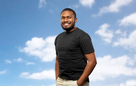 smiling african american man over blue sky