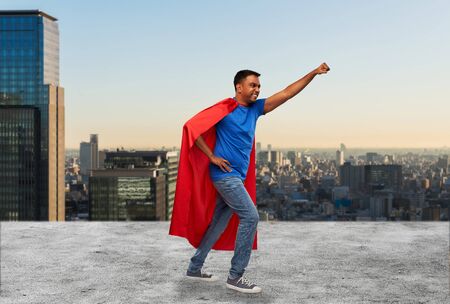 indian man in superhero cape makes winning gestureの写真素材
