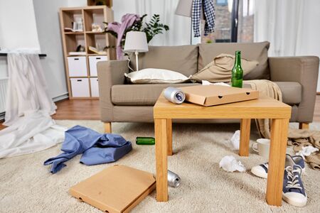 mess, disorder and interior concept - view of messy home living room with scattered stuffの写真素材