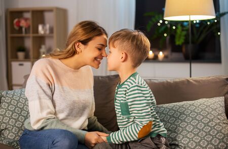 happy mother and son touching noses at homeの写真素材