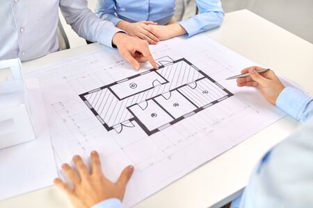 close up of architects with blueprint at office