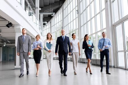 business people walking along office buildingの写真素材