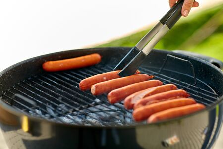 meat sausages roasting on hot brazier grillの写真素材