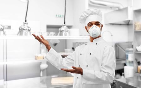 male chef in respirator at restaurant kitchen