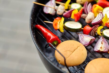 vegetables and burger buns roasting on grill