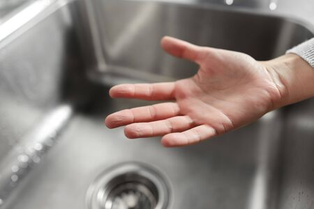 close up of clean womans hand over kitchen sinkの写真素材