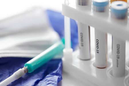 beakers with coronavirus blood test in holder