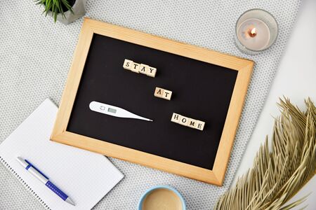 chalkboard with stay at home words on toy blocks