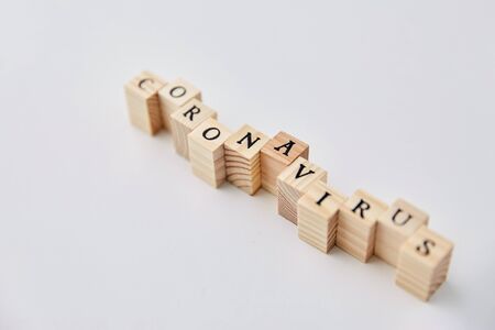 coronavirus word on wooden toy blocks on whiteの写真素材