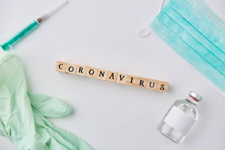 coronavirus word, mask, gloves, syringe and drugの写真素材