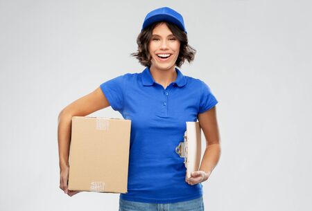 happy delivery girl with parcel box and clipboardの写真素材