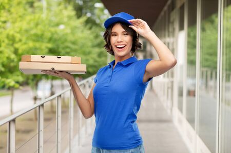 delivery woman with takeaway pizza boxesの写真素材