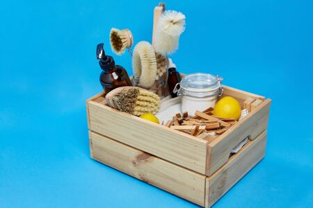 natural cleaning stuff, sustainability and eco living concept - wooden box with washing soda, lemon,...