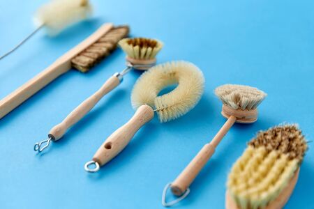 different cleaning brushes on blue background