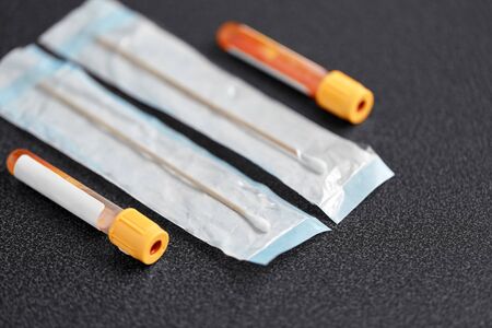 test tubes with blood plasma and cotton swabsの写真素材