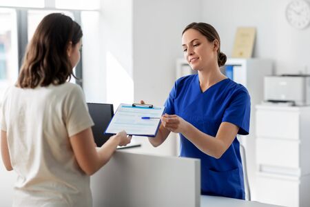 doctor with clipboard and patient at hospital