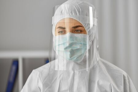 doctor in protective wear, mask and face shield
