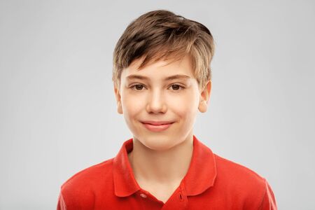 portrait of happy smiling boy in red polo t-shirt