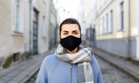 woman wearing protective reusable mask in cityの写真素材