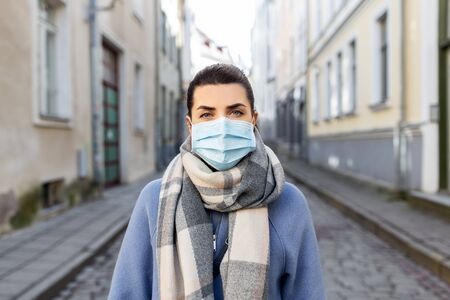 woman wearing protective medical mask in cityの写真素材