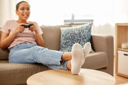 african american woman with gamepad playing game
