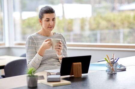 young woman with tablet pc working at home officeの写真素材
