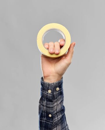 close up of builders hand holding paper tapeの写真素材