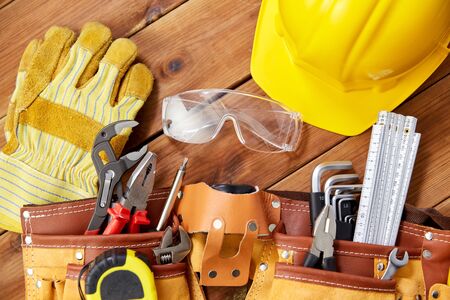 different work tools in belt on wooden boards