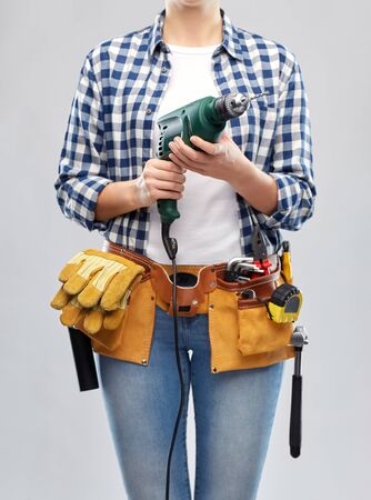 woman or builder with drill and work toolsの写真素材