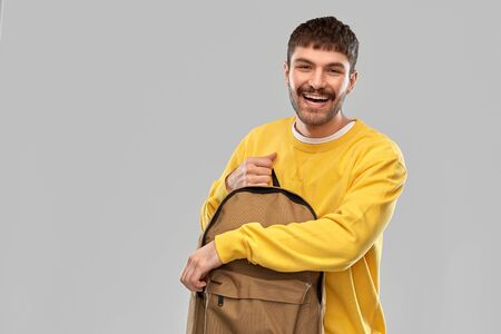 happy smiling young man with backpackの写真素材