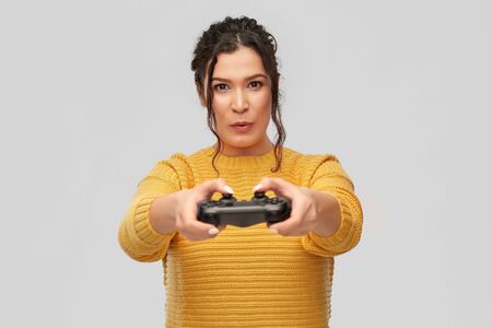 happy young woman with gamepad playing video game