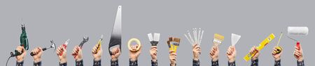 builders hands holding different working tools
