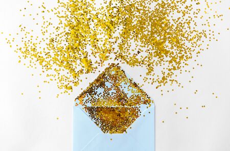 golden glitters and envelope on white backgroundの写真素材