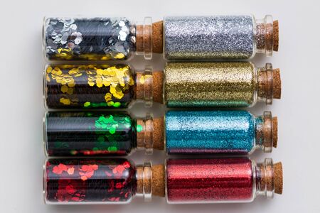 set of glitters in bottles over white background