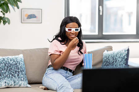 happy african american woman watching tv at home