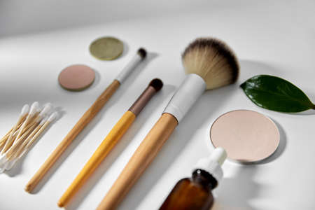 make up brushes, cosmetics and cotton swabs