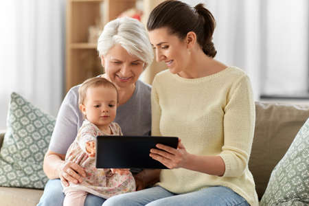 mother, daughter and grandma with tablet pc
