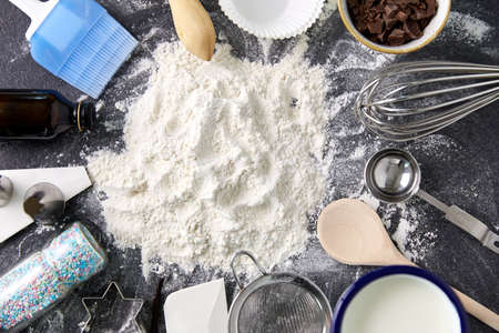 flour with baking and cooking ingredients on tableの写真素材